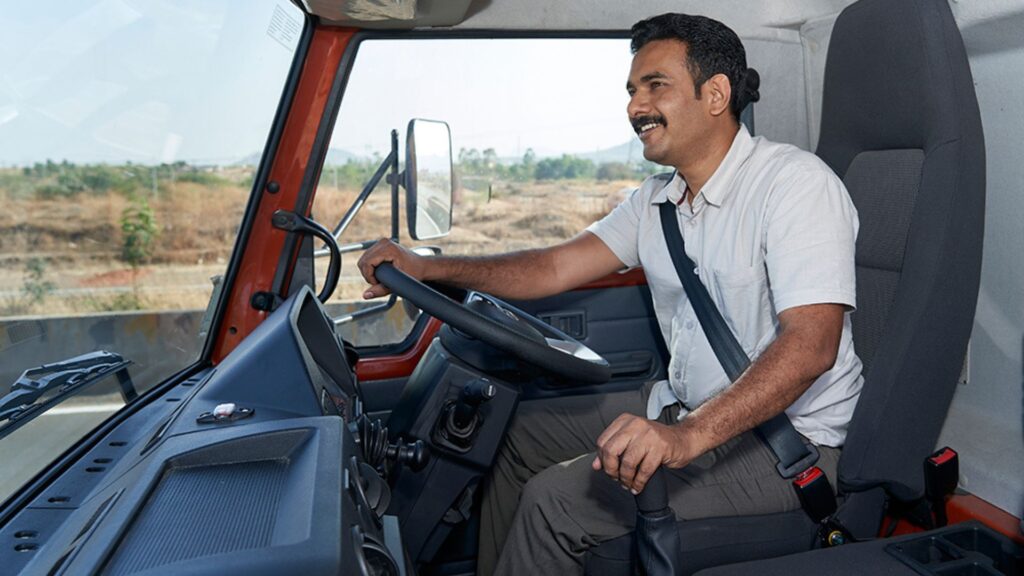 Driver on driving seat in truck cabin